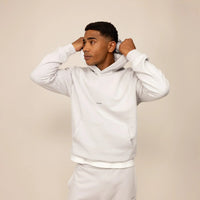 Man wearing a Marame cotton fleece Logo Hoodie in Ash White, front view.|ash white