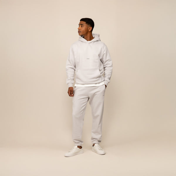 Man wearing a Marame cotton fleece Logo Hoodie in Ash White, full view.