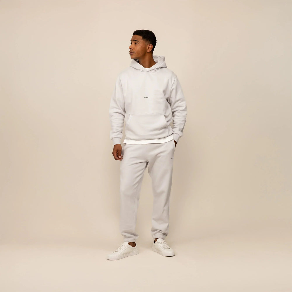 Man wearing a Marame cotton fleece Logo Hoodie in Ash White, full view.|ash white
