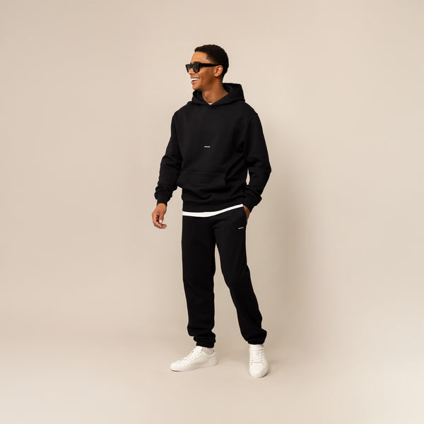 Man wearing a Marame Cotton Fleece Logo Hoodie in Black, full view.