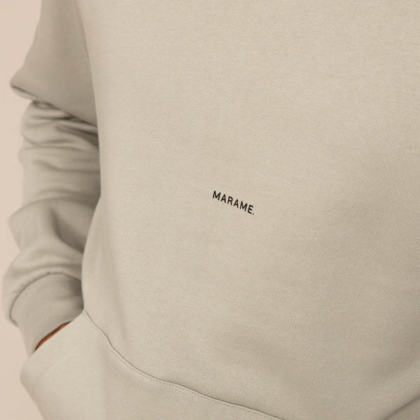Man wearing a cotton fleece Logo Hoodie in Wolf Grey, closeup.