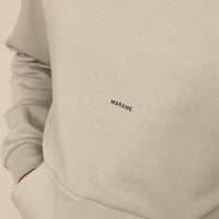 Man wearing a cotton fleece Logo Hoodie in Wolf Grey, closeup.