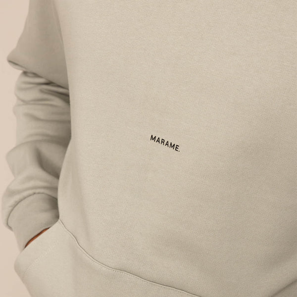 Man wearing a cotton fleece Logo Hoodie in Wolf Grey, closeup.|Wolf Green