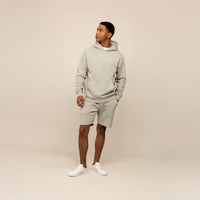 Man wearing a Marame cotton fleece Logo Hoodie in Wolf Grey, full view.|Wolf Green