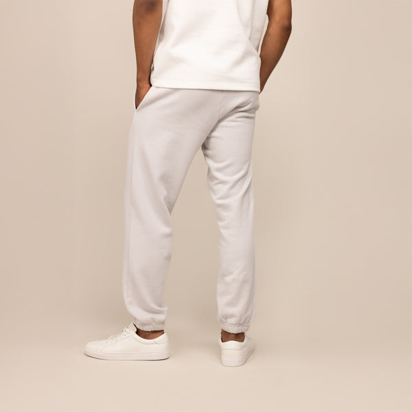 Man wearing Cotton Fleece Joggers in Ash White, rear view.