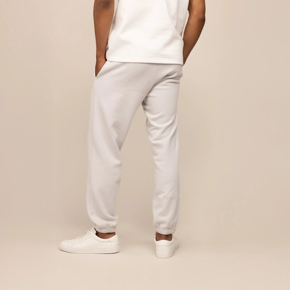 Man wearing Cotton Fleece Joggers in Ash White, rear view.