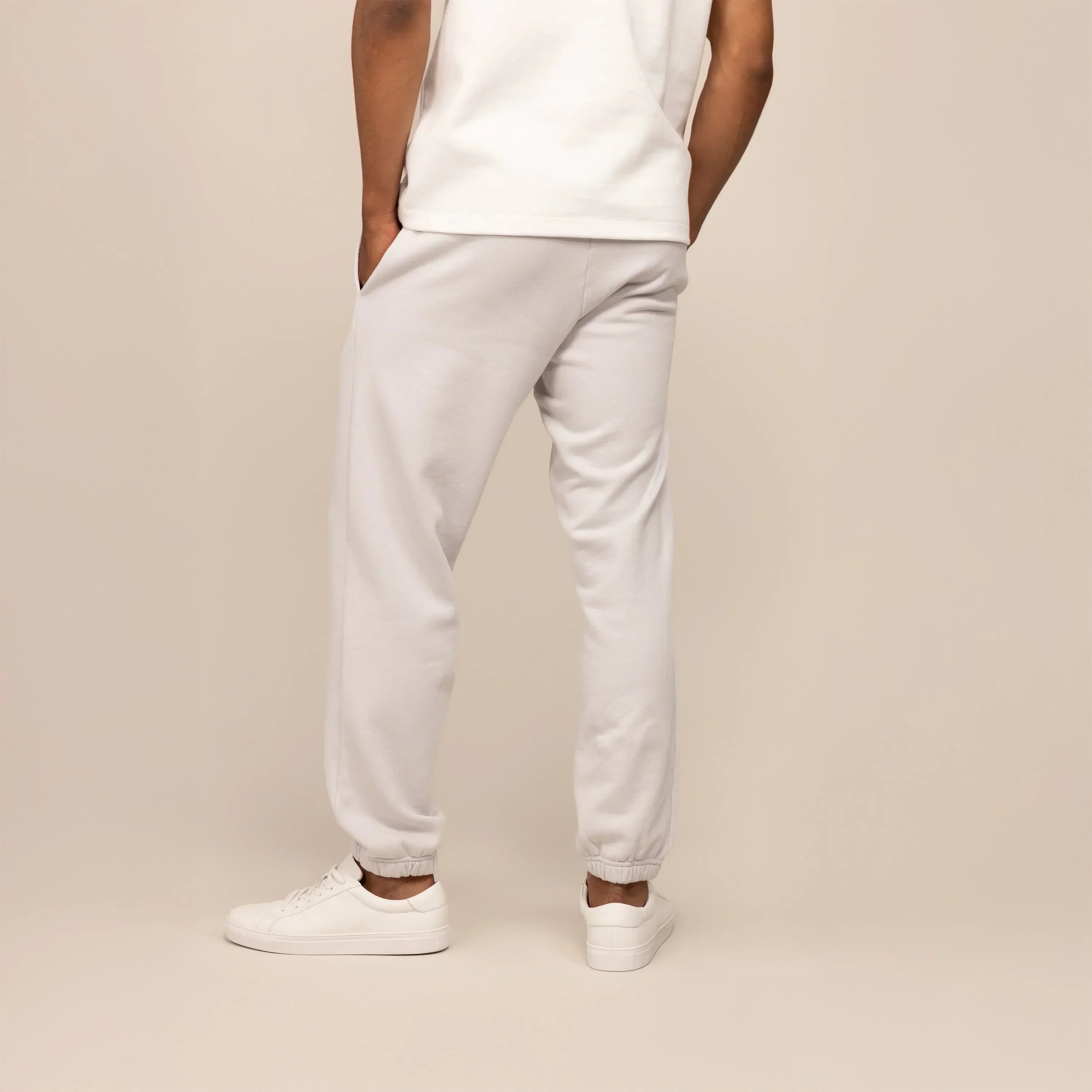 Man wearing Cotton Fleece Joggers in Ash White, rear view.|ash white