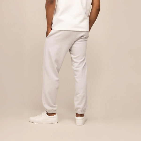 Man wearing Cotton Fleece Joggers in Ash White, rear view.|ash white