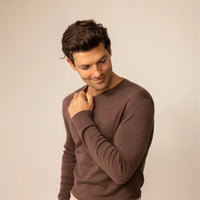 Man wearing a Marame Fine Knit Crew Neck Jumper in Conker Brown, front view.