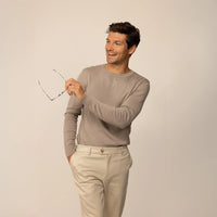 Man wearing a Marame Fine Knit Crew Neck Jumper in Putty Dove, front view.