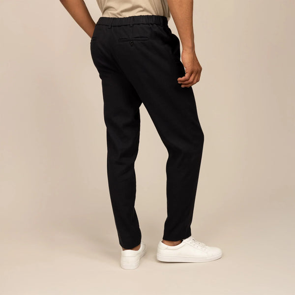 Man wearing Casual Linen Blend Trousers in Black, rear view.