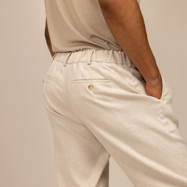 Man wearing Casual Linen Blend Trousers in Woven Sand, rear view.