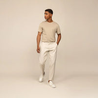 Man wearing Marame Casual Linen Blend Trousers in Woven Sand, front view.