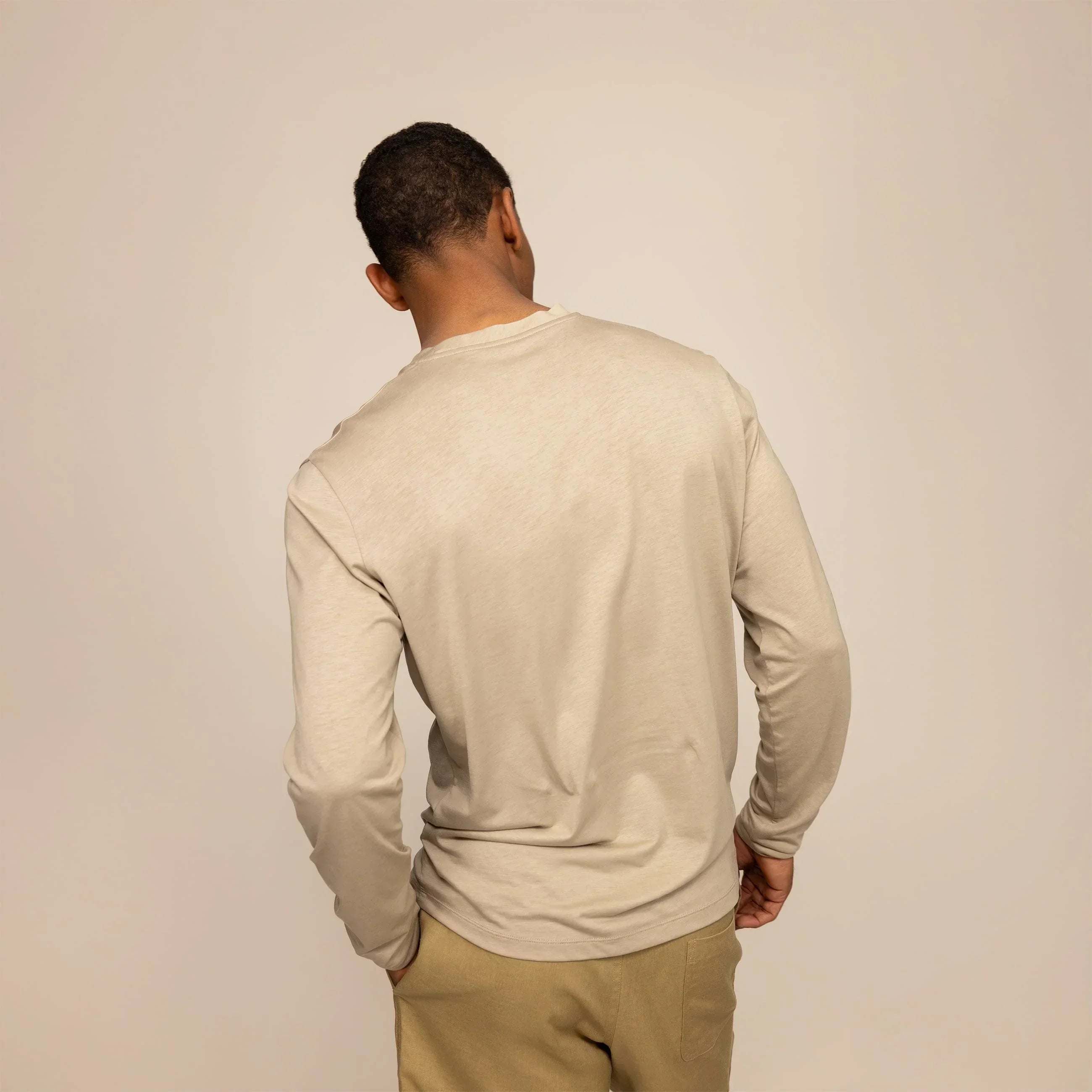 Man wearing a Long Sleeve Logo T-Shirt in Canyon Clay, rear view. |canyon clay