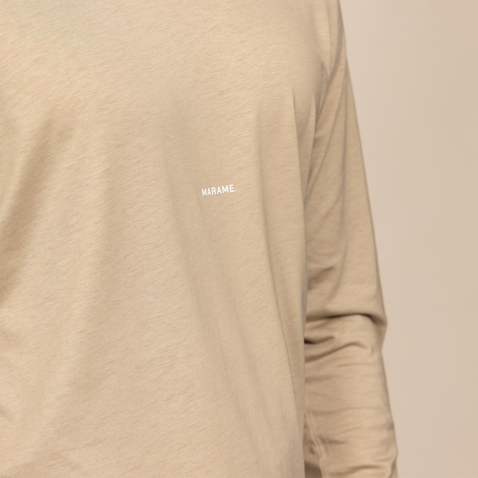 Man wearing a Marame Long Sleeve Logo T-Shirt in Canyon Clay, closeup.