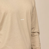 Man wearing a Marame Long Sleeve Logo T-Shirt in Canyon Clay, closeup.