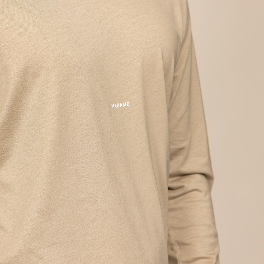 Man wearing a Marame Long Sleeve Logo T-Shirt in Canyon Clay, closeup. |canyon clay