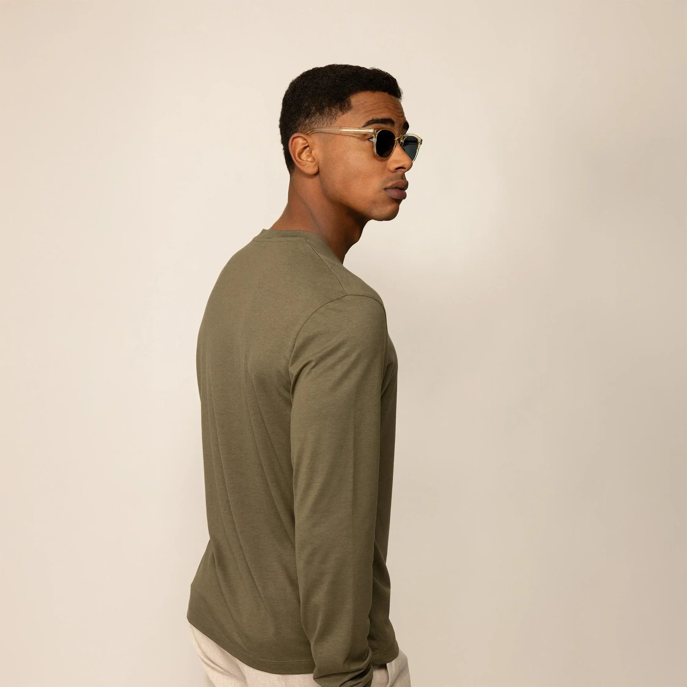 Man wearing a Long Sleeve Logo T-Shirt in Olive, rear view. |olive