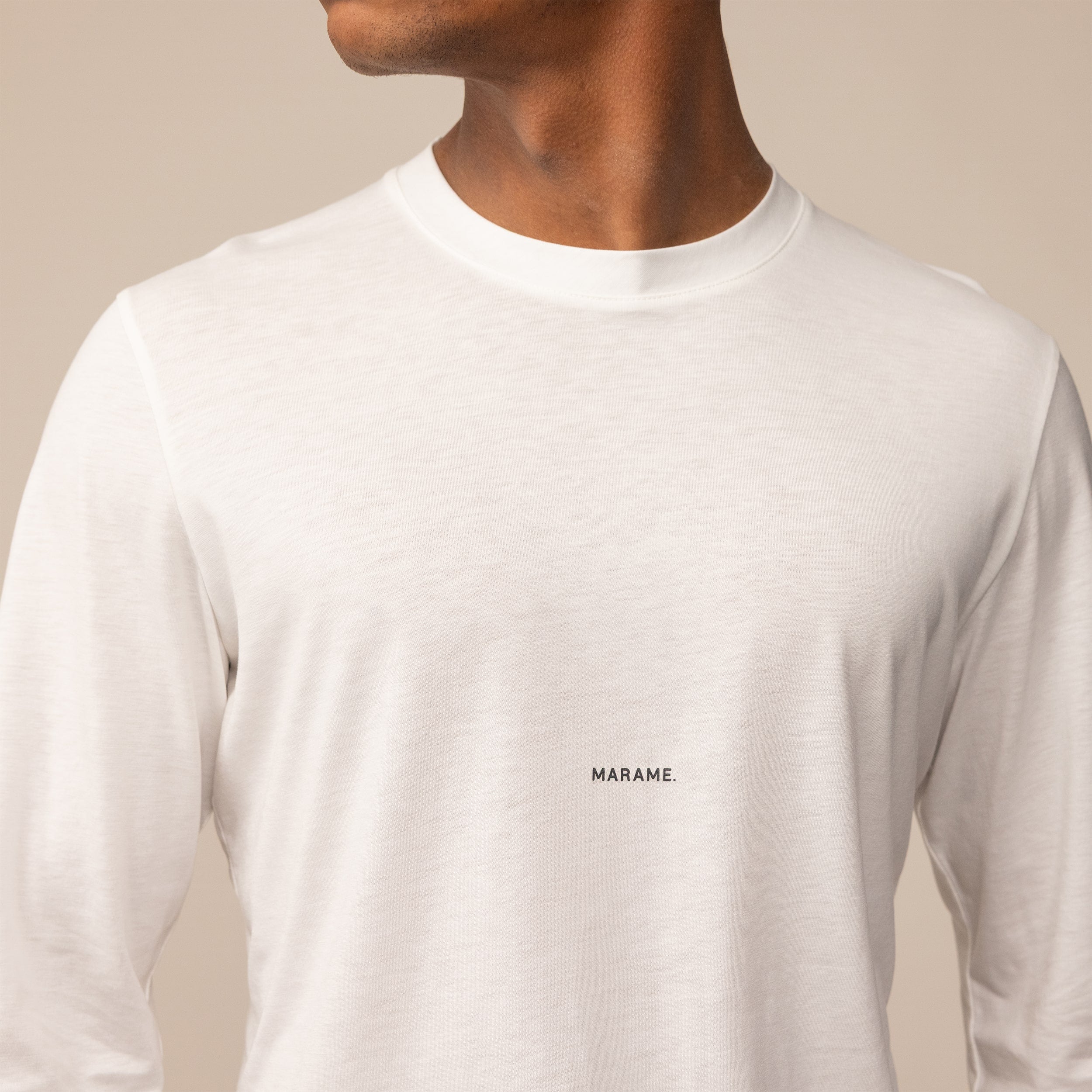 Man wearing a Long Sleeve Logo T-Shirt in White, closeup.