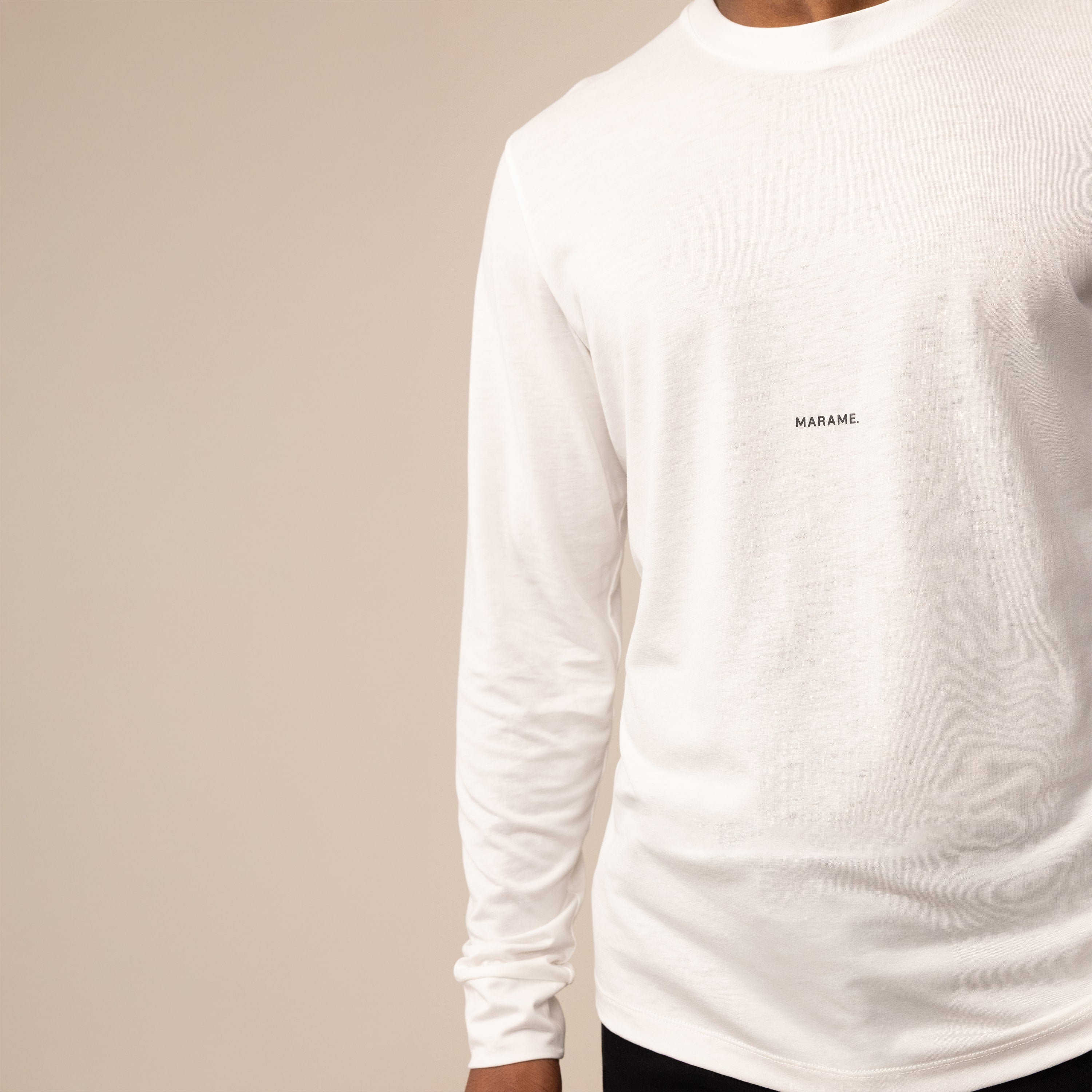 Man wearing a Long Sleeve Logo T-Shirt in White, closeup.