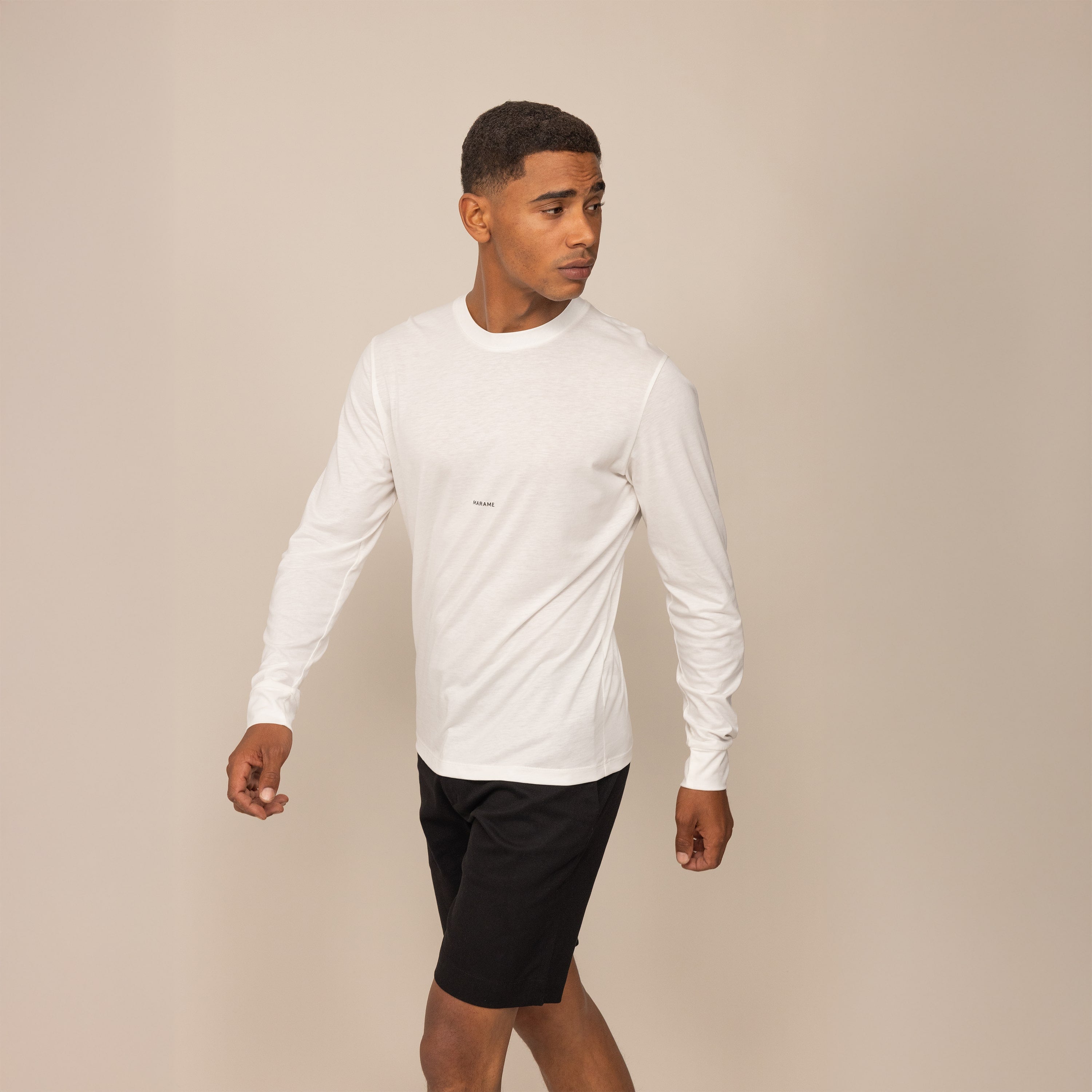 Man wearing a Marame Long Sleeve Logo T-Shirt in White, front view.