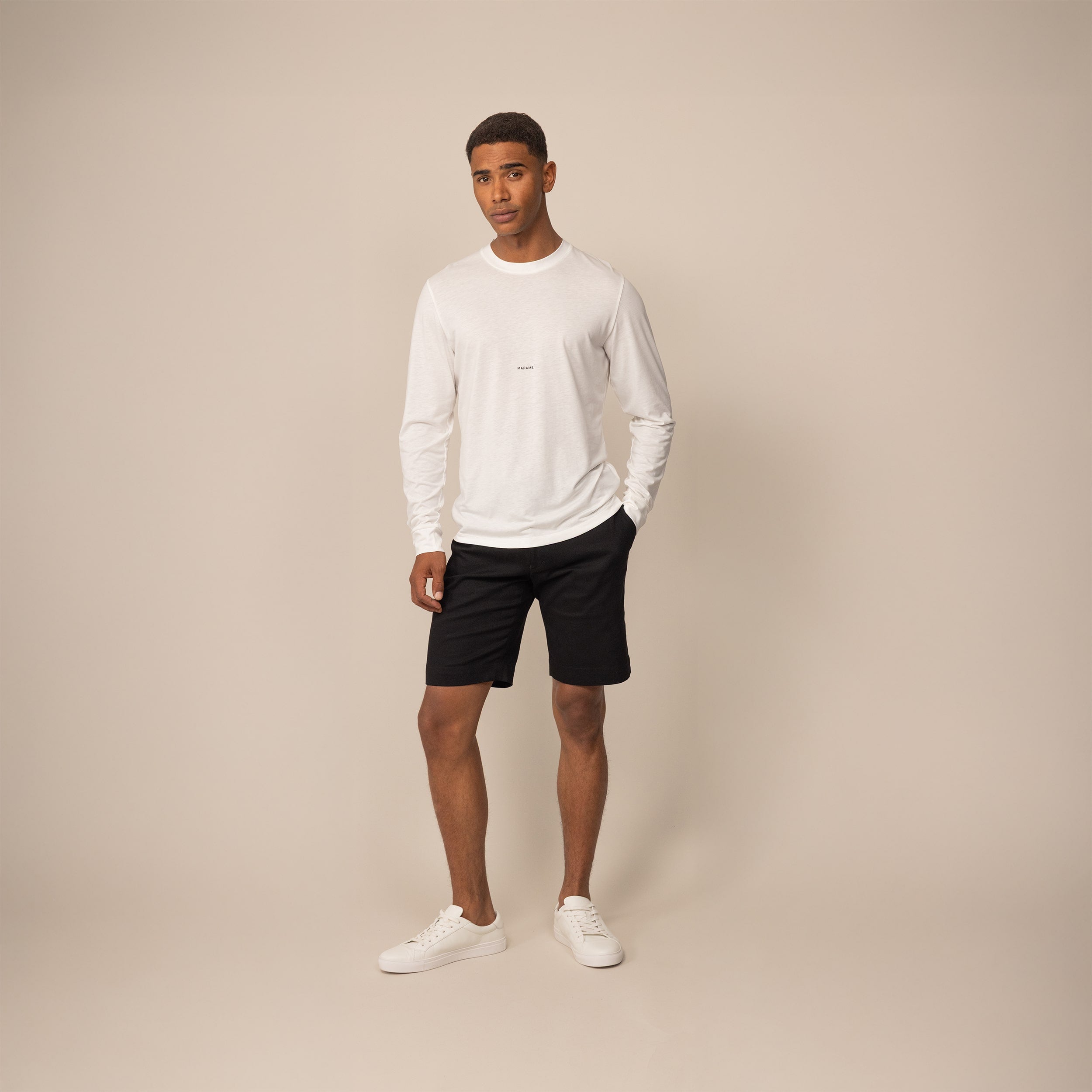 Man wearing a Marame Long Sleeve Logo T-Shirt in White, front view.