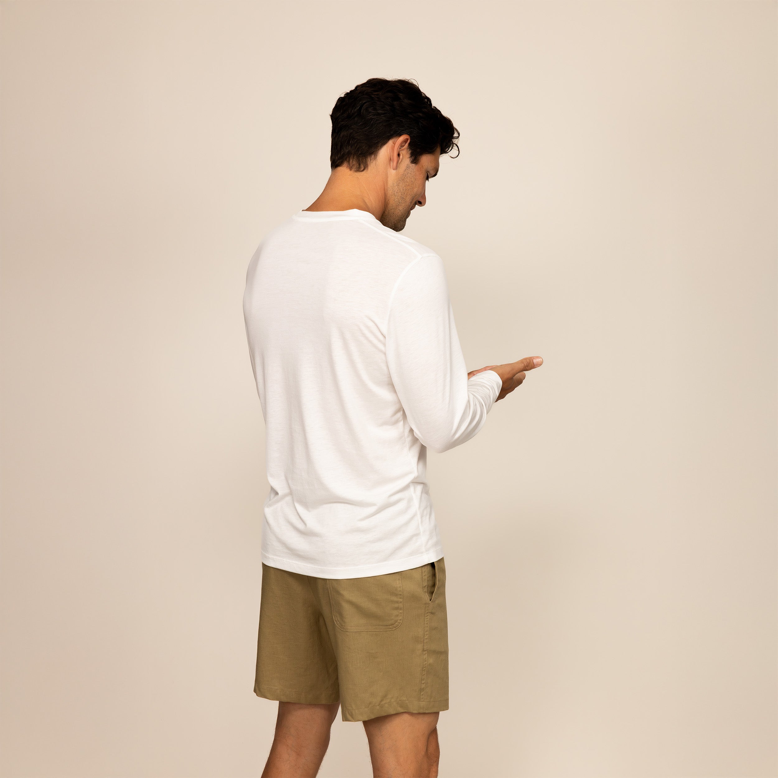 Man wearing a Long Sleeve T-Shirt in White, rear view.