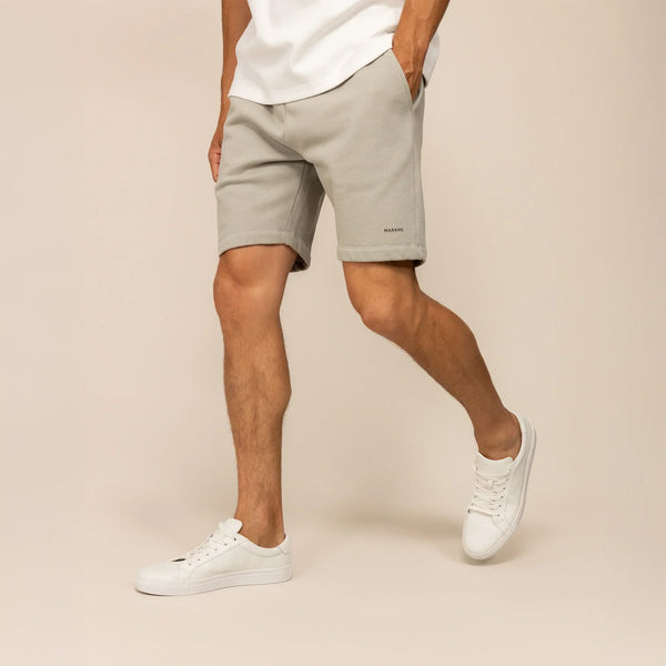 Man wearing Marame Lounge Shorts in Wolf Grey, front view.