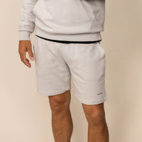 Man wearing Lounge Shorts in Ash White, front view.
