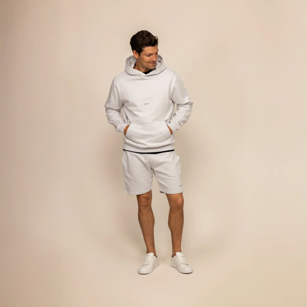 Man wearing Marame Lounge Shorts in Ash White, front view.