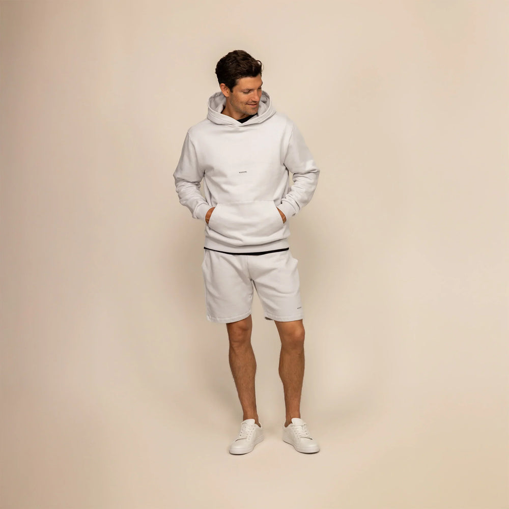 Man wearing Marame Lounge Shorts in Ash White, front view.