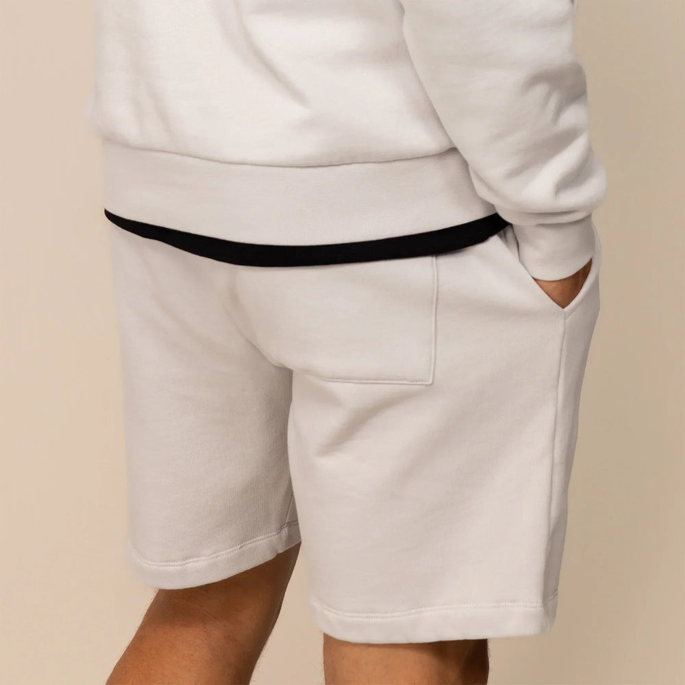 Man wearing Marame Lounge Shorts in Ash White, rear view. |ash white