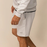 Man wearing Lounge Shorts in Ash White, side view.