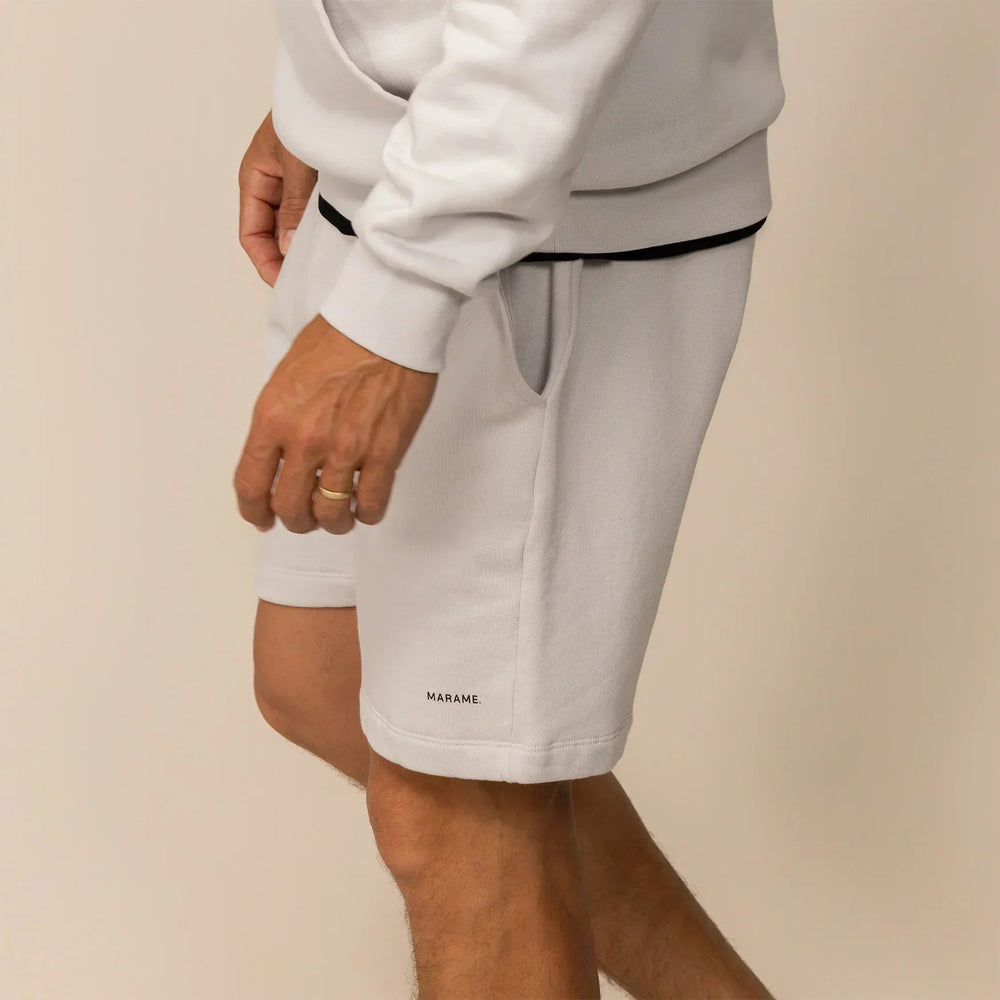 Man wearing Lounge Shorts in Ash White, side view. |ash white