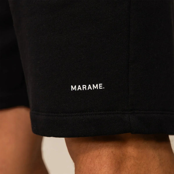 Man wearing Marame Lounge Shorts in Black, closeup.