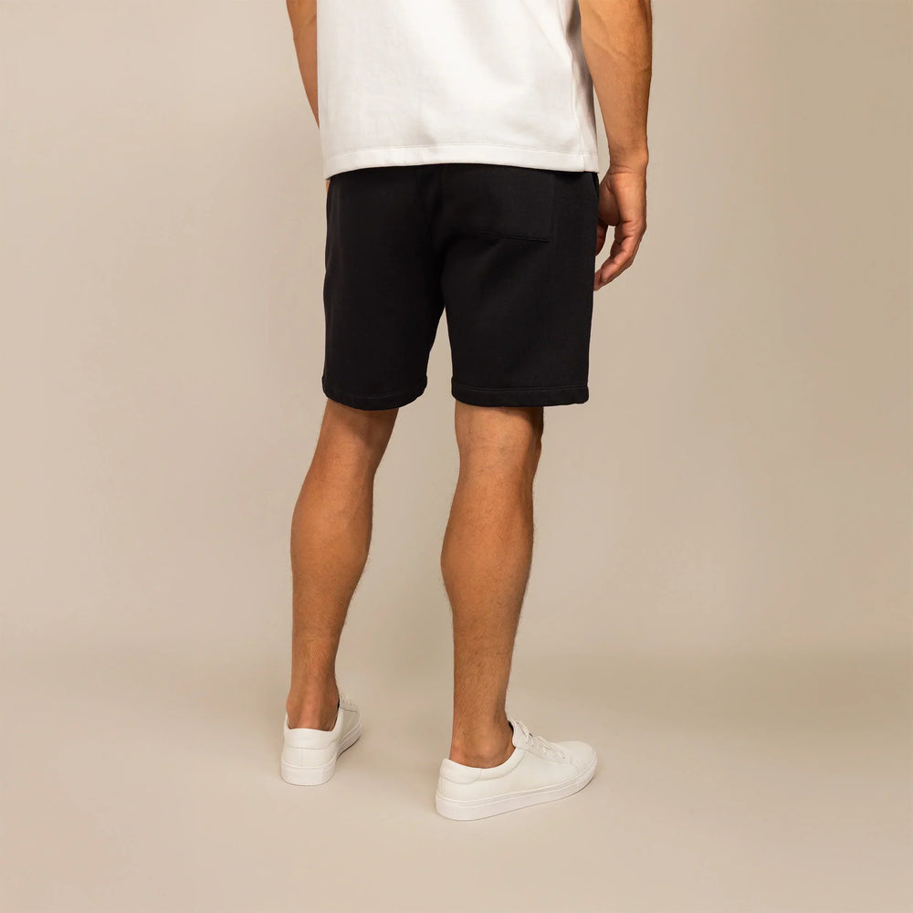 Man wearing Lounge Shorts in Black, rear view.