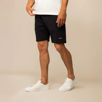 Man wearing Marame Lounge Shorts in Black, front view.