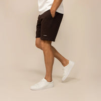 Man wearing Lounge Shorts in Smoked Brown, side view.