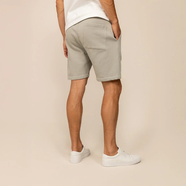 Man wearing Marame Lounge Shorts in Wolf Grey, rear view.