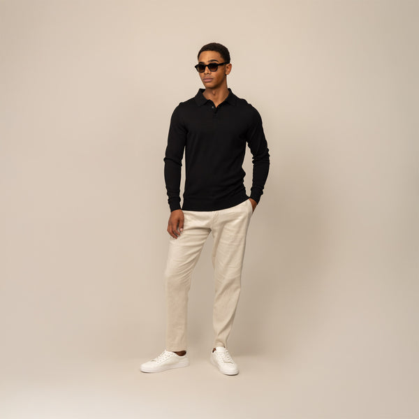 Man wearing a Marame Merino Cotton Long Sleeve Polo in Black, front view.