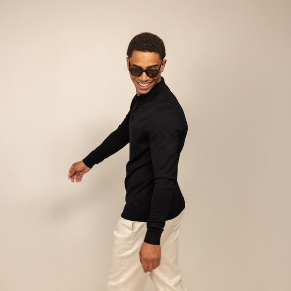 Man wearing a Marame Merino Cotton Long Sleeve Polo in Black, rear view.