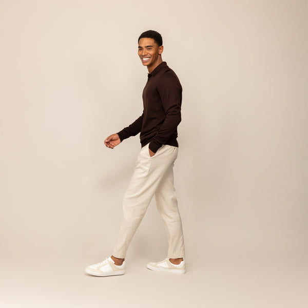 Man wearing a Marame Merino Cotton Long Sleeve Polo in Brown Cherry, front view.