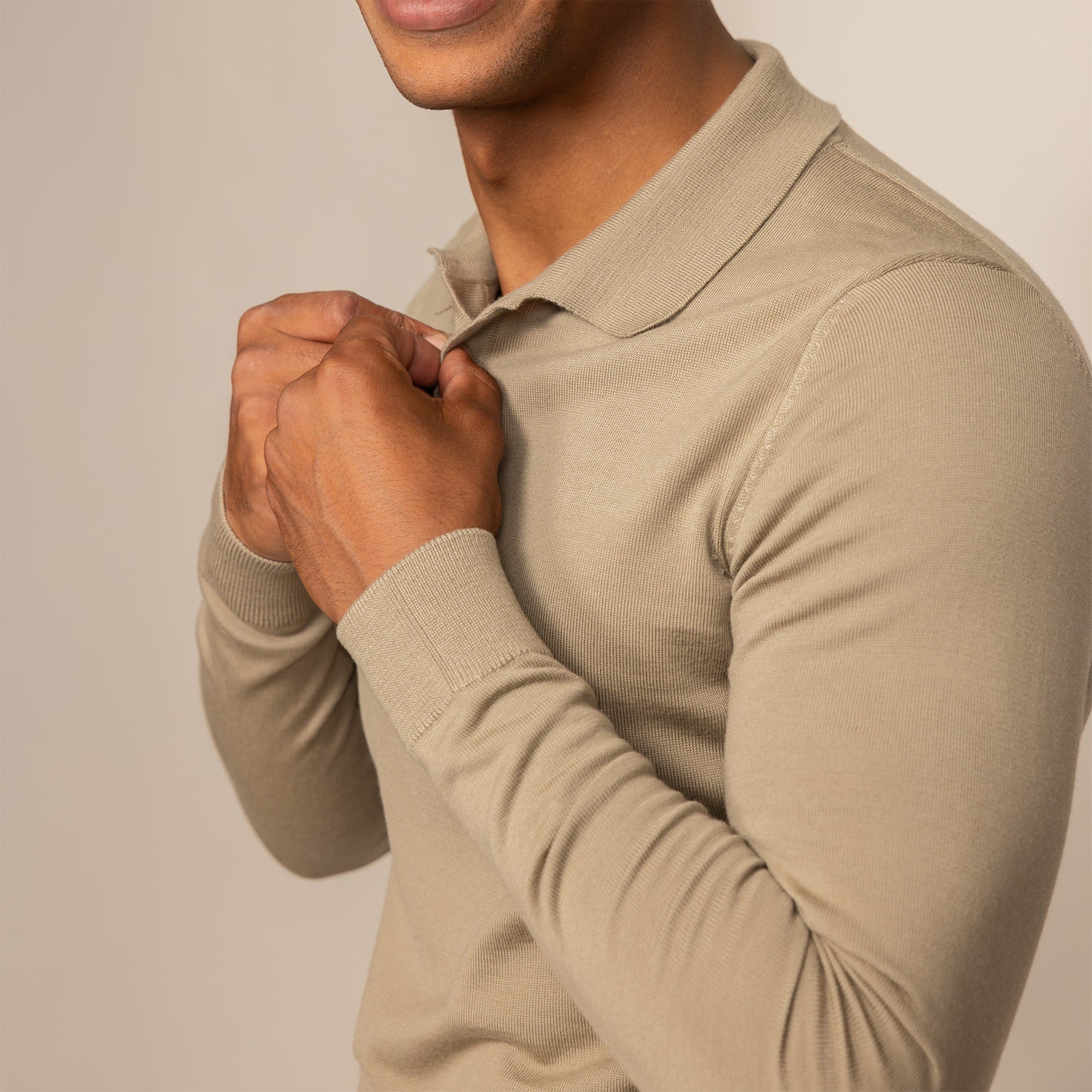 Man wearing a Marame Merino Cotton Long Sleeve Polo in Shadow Grey, closeup.
