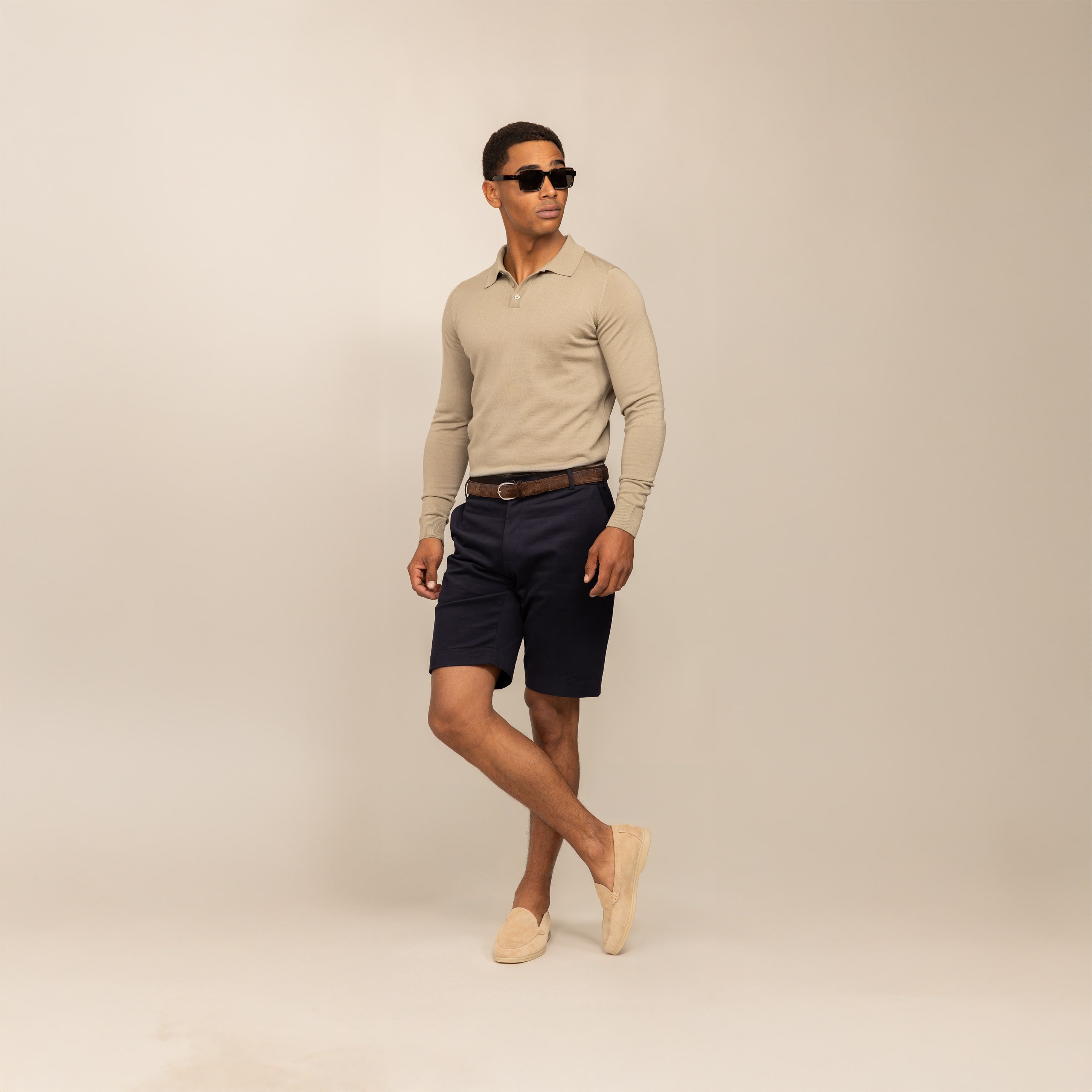 Man wearing a Marame Merino Cotton Long Sleeve Polo in Shadow Grey, front view.