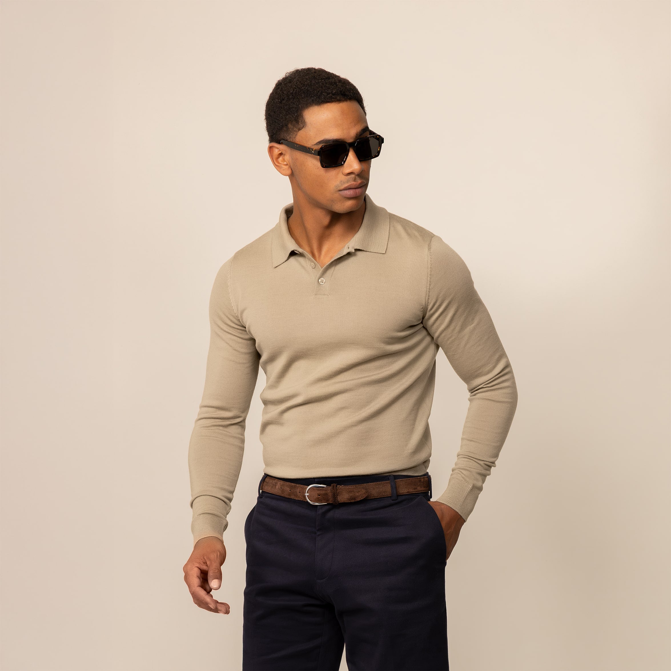 Man wearing a Marame Merino Cotton Long Sleeve Polo in Shadow Grey, front view.