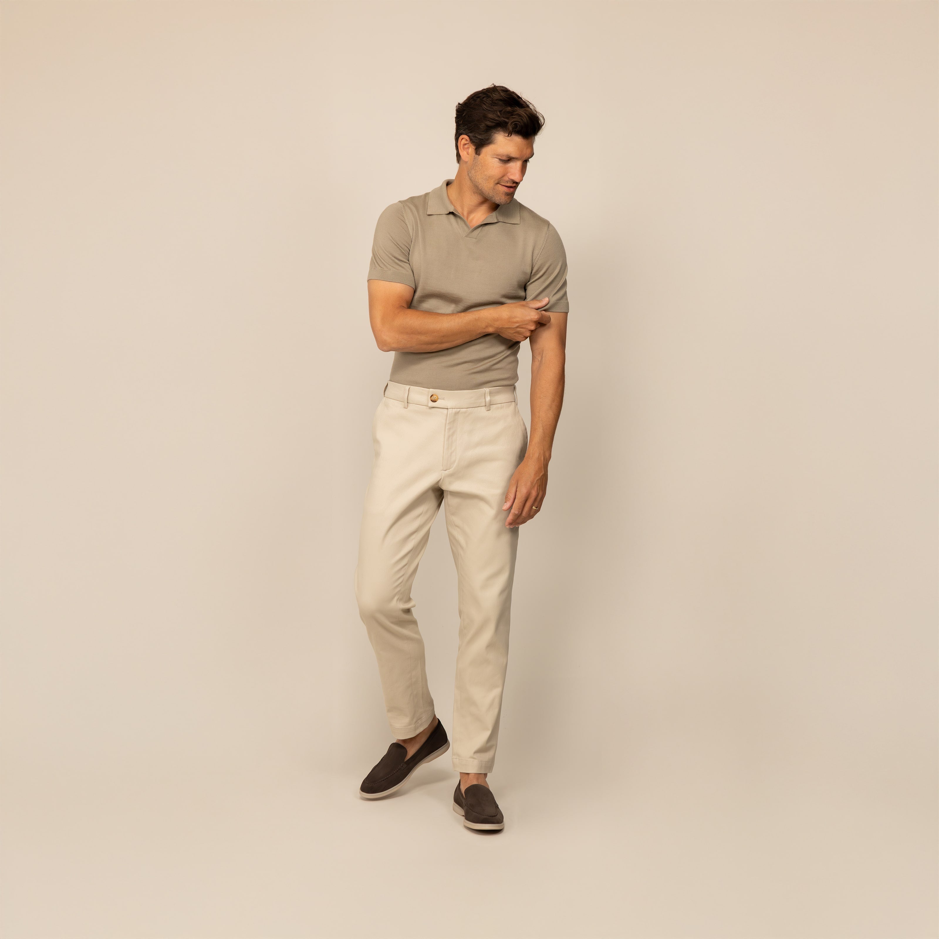 Man wearing a Marame Merino Cotton Open Collar Short Sleeve Polo in Shadow Grey, front view.