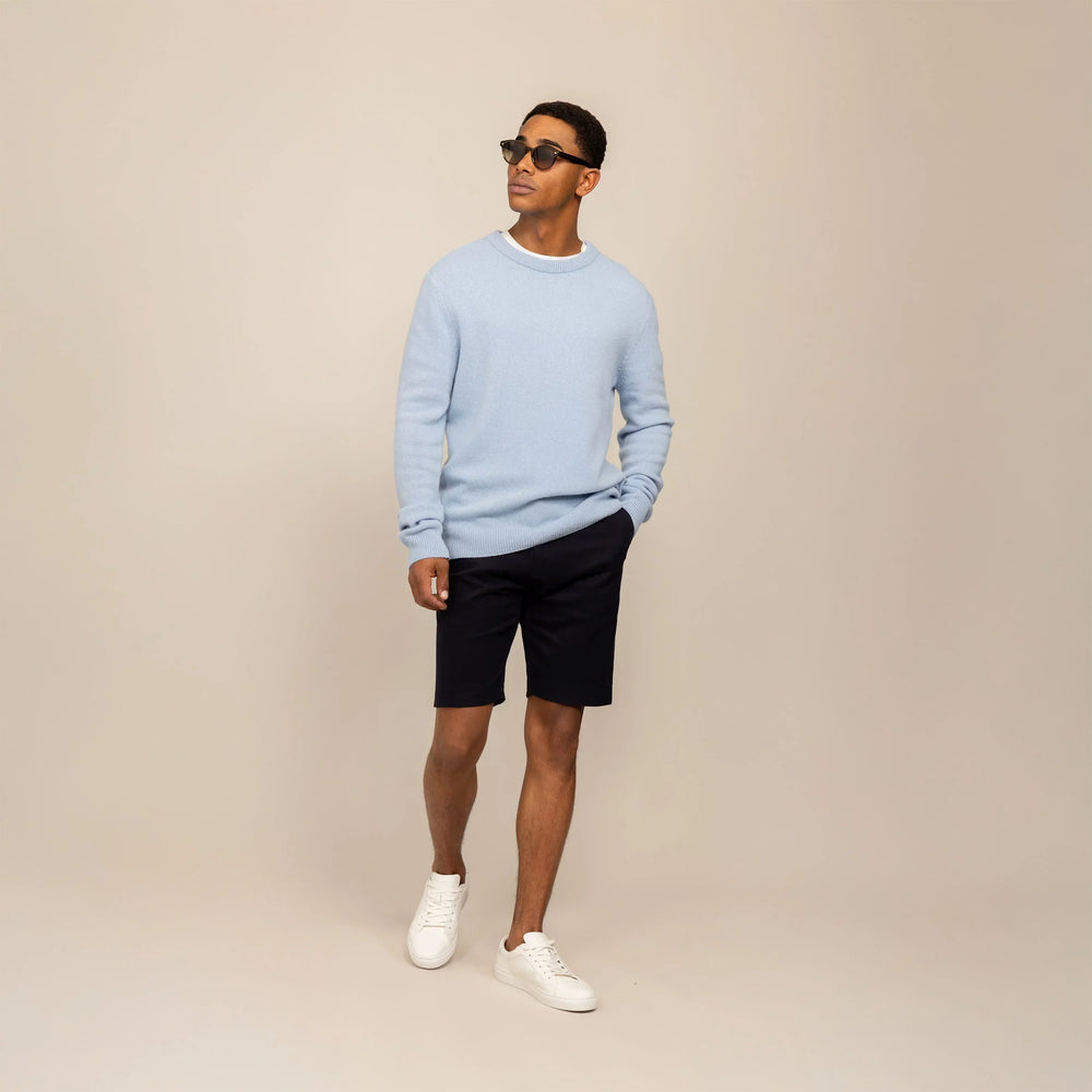 Man wearing a Marame Merino Wool Crew Neck Knit Jumper in Blushing Blue, front view.