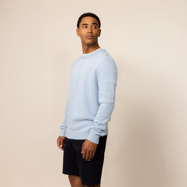 Man wearing a Marame Merino Wool Crew Neck Knit Jumper in Blushing Blue, front view.|blushing blue