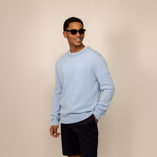 Man wearing a Marame Merino Wool Crew Neck Knit Jumper in Blushing Blue, front view.