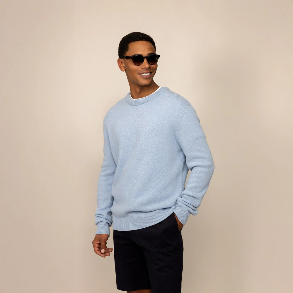 Man wearing a Marame Merino Wool Crew Neck Knit Jumper in Blushing Blue, front view.